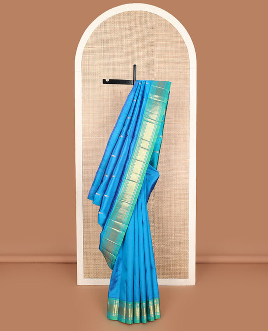 Blue zari buttas Kanchipuram silk saree, contrast one-sided border of paneer sombu, banaras, muthu, and jaal designs, and zari design pallu