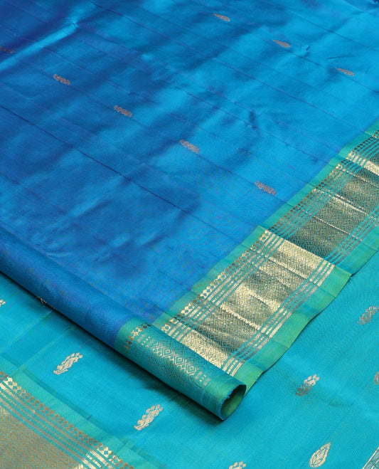Blue zari buttas Kanchipuram silk saree, contrast one-sided border of paneer sombu, banaras, muthu, and jaal designs, and zari design pallu