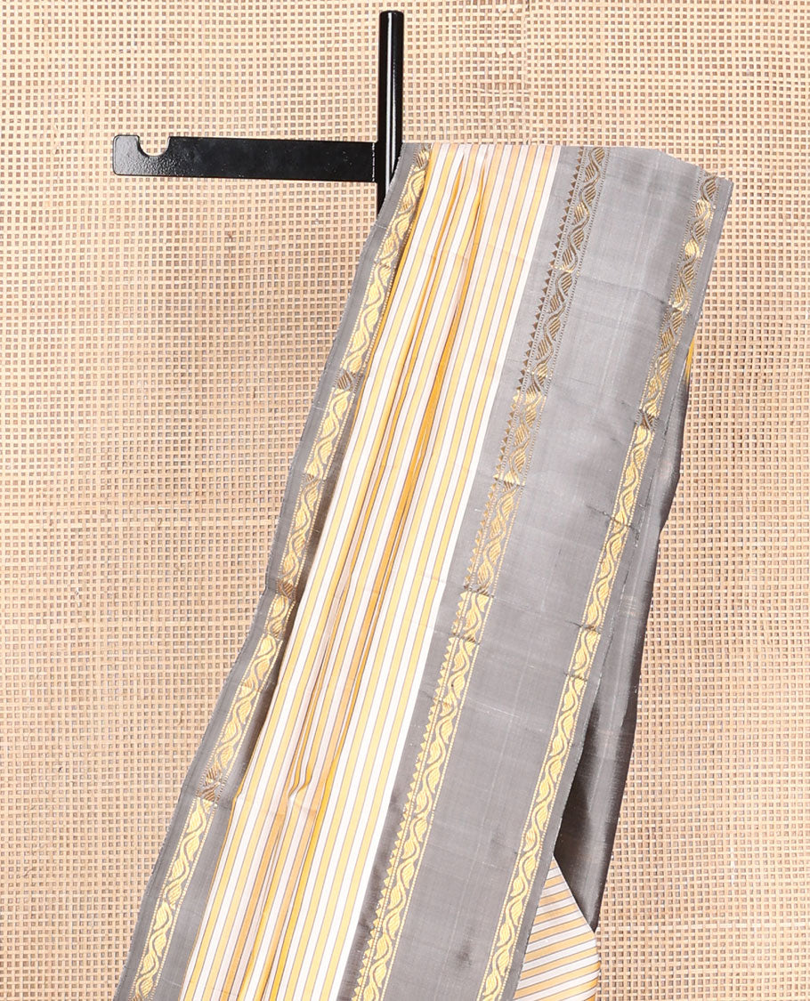 Yellow-white striped kanchipuram silk saree, contrast rettai pettu border of rekku, muthu & leaf vine & pallu of zari stripes