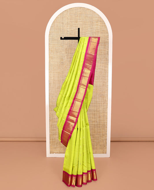 Green Kanchipuram Silk Saree, Meticulously Crafted with Zari Buttas All Over Its Body, Complemented by a Contrast One-Sided Korvai Border of Thilakam Mokku, and Puli Nagam Designs, Pallu of Zari Designs, and Comes Without a Blouse