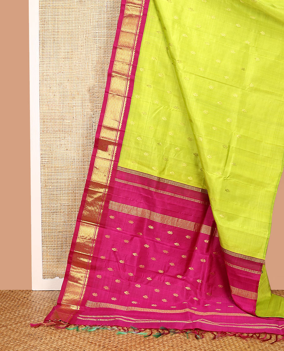 Green Kanchipuram Silk Saree, Meticulously Crafted with Zari Buttas All Over Its Body, Complemented by a Contrast One-Sided Korvai Border of Thilakam Mokku, and Puli Nagam Designs, Pallu of Zari Designs, and Comes Without a Blouse