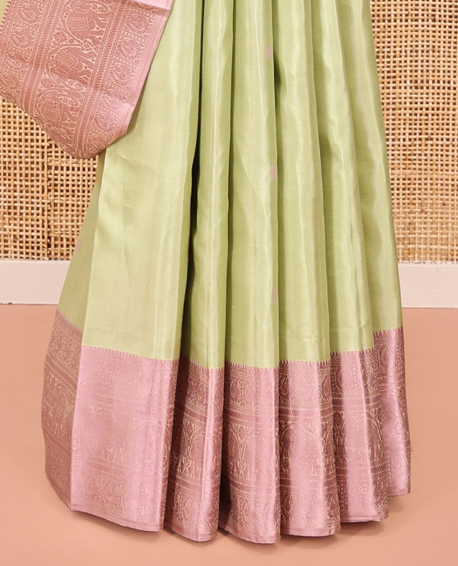 Pale Green Kanchipuram Designer Silk Saree, Subtly Sparkled With Buttas All Over Its Body Complemented by Contrast Traditional Designs Threaded Border, Subtly Woven Pallu, and Paired with a Contrast Blouse