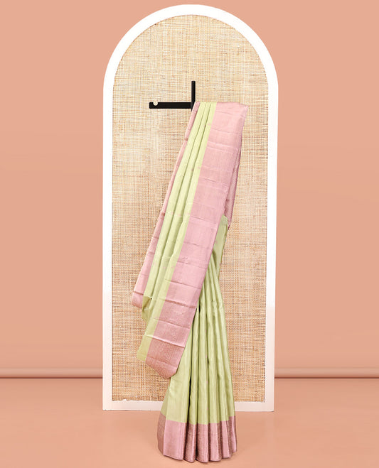 Pale Green Kanchipuram Designer Silk Saree, Subtly Sparkled With Buttas All Over Its Body Complemented by Contrast Traditional Designs Threaded Border, Subtly Woven Pallu, and Paired with a Contrast Blouse
