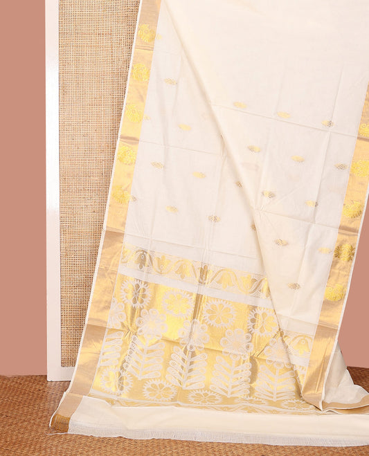 Cream Kerala Saree, Prettified with Zari Buttas on Its Body, Scintillating Zari Border, Sparkling Zari Woven Pallu of Flower Designs, and Paired with a Matching Blouse