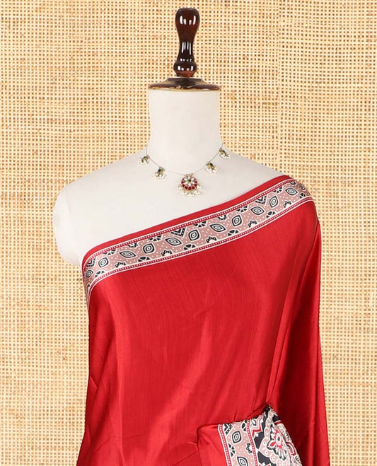 Red half-&-half style modal satin saree features floral & geometric design Ajrakh printed contrast border & pallu