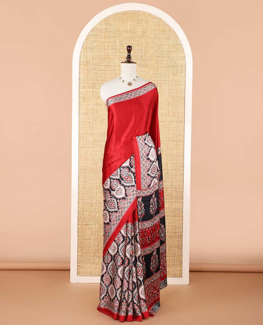 Red half-&-half style modal satin saree features floral & geometric design Ajrakh printed contrast border & pallu