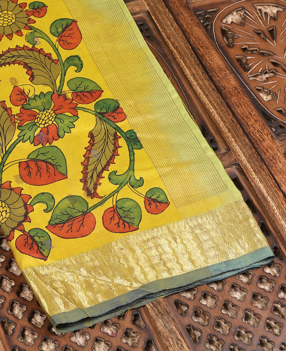 Yellow handpainted pen Kalamkari silk saree with floral design, contrast kanchi border & pallu of intricate floral jaal