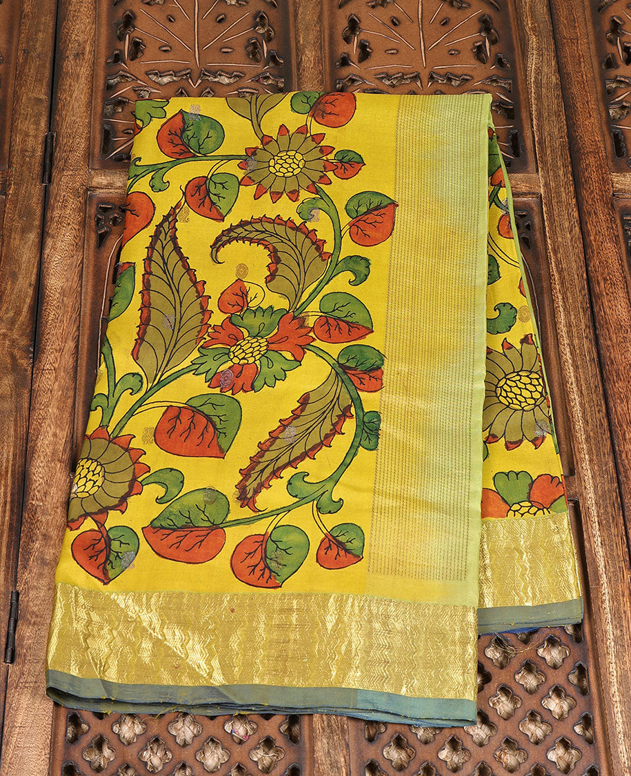 Yellow handpainted pen Kalamkari silk saree with floral design, contrast kanchi border & pallu of intricate floral jaal
