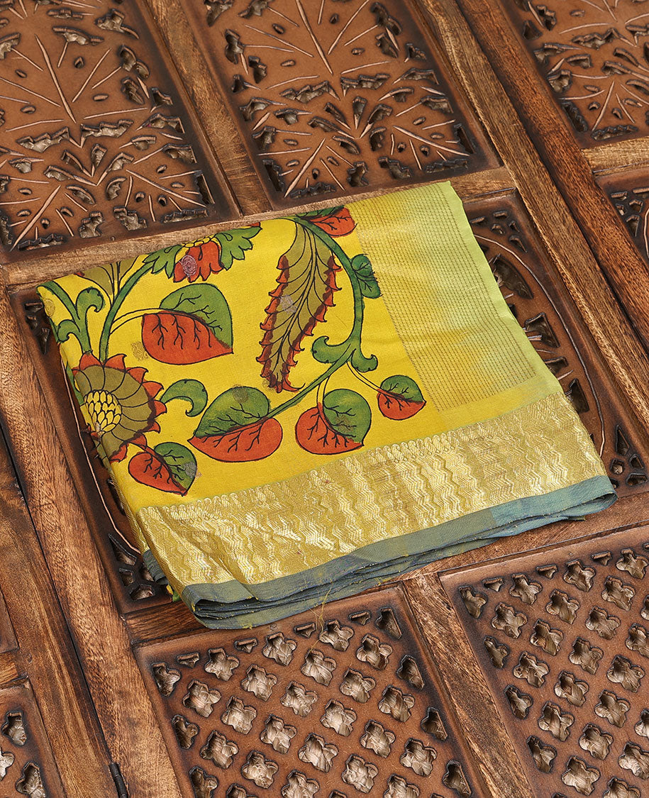 Yellow handpainted pen Kalamkari silk saree with floral design, contrast kanchi border & pallu of intricate floral jaal