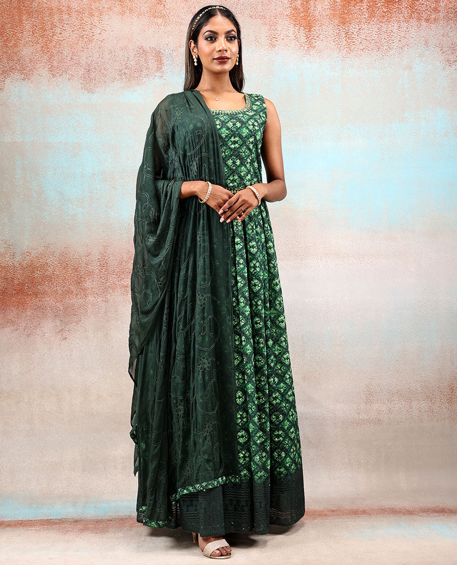 Green printed georgette Anarkali features intricate motifs, mirror work neck & thread embroidered border & dupatta  