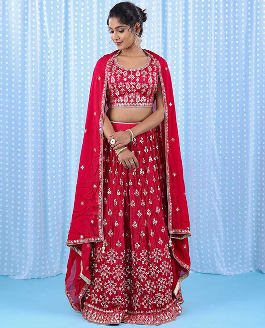 Cherry red georgette readymade floor touch lehenga with floral theme chamki embroidered on its crop top, skirt & dupatta