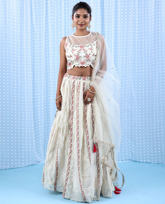 Cream Raw Silk Readymade lehenga features floral vine embroidered skirt,scallop & boat net necked crop top & net dupatta