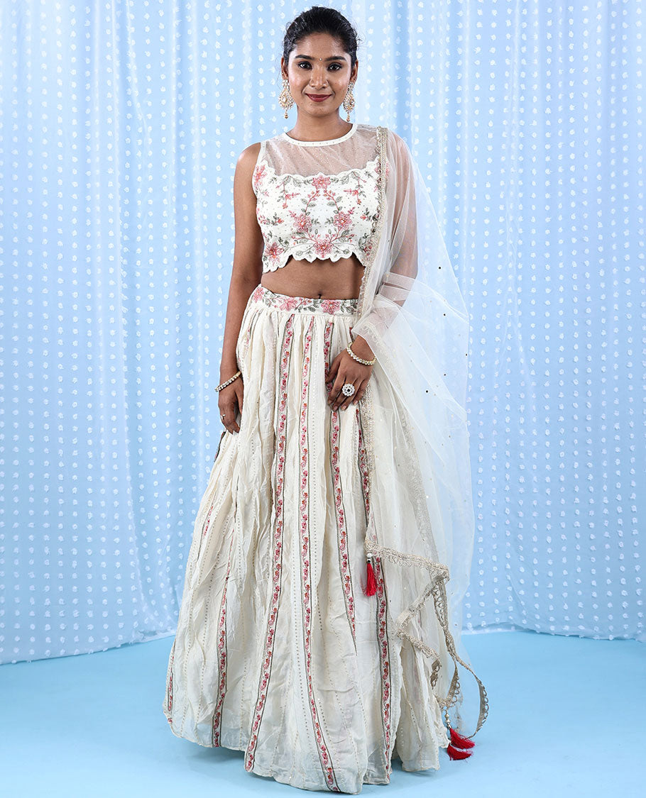 Cream Raw Silk Readymade lehenga features floral vine embroidered skirt,scallop & boat net necked crop top & net dupatta