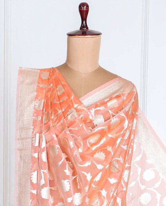 Pastel orange Banaras-style organza dupatta features floral jaal designs with tassels