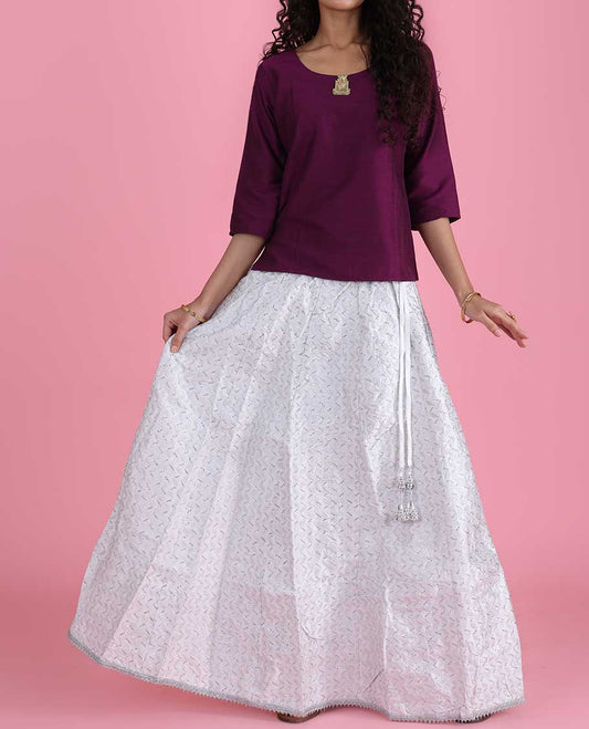 White silk cotton material skirt features chevron design sequin embroidery with lace border