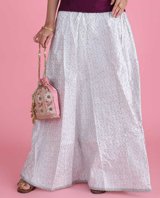 White silk cotton material skirt features chevron design sequin embroidery with lace border