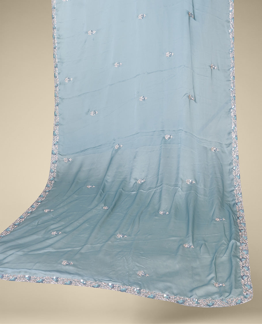 Pastel green embroidered satin silk saree features intricate designs in chamki, crystal stone & sliver thread