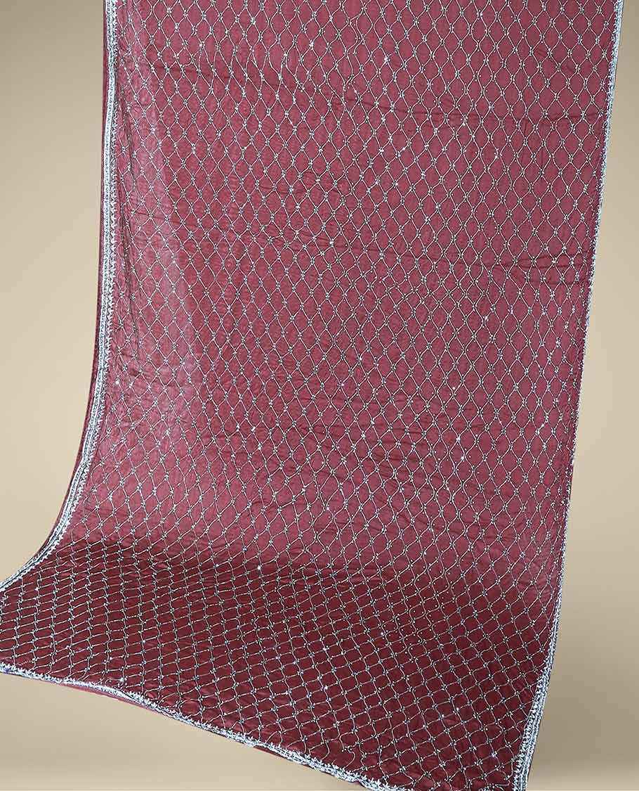 Wine red bridal saree features crystal stone embroidered ogee pattern all over its body, stone work border