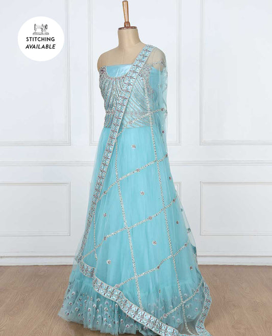 Enthralling blue lehenga set features plain ruffle net skirt with sequins embroidery,intricate embroidered top & dupatta