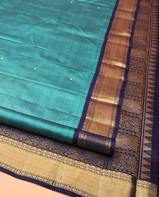 Blue Kanchipuram Silk Saree, Beautified with Zari Buttas All Over Its Body, Complemented by a Contrast Border of Thilakam, Muthu, Poun, and Vanki Designs, Grand Jaal Pallu, and Paired with a Contrast Blouse