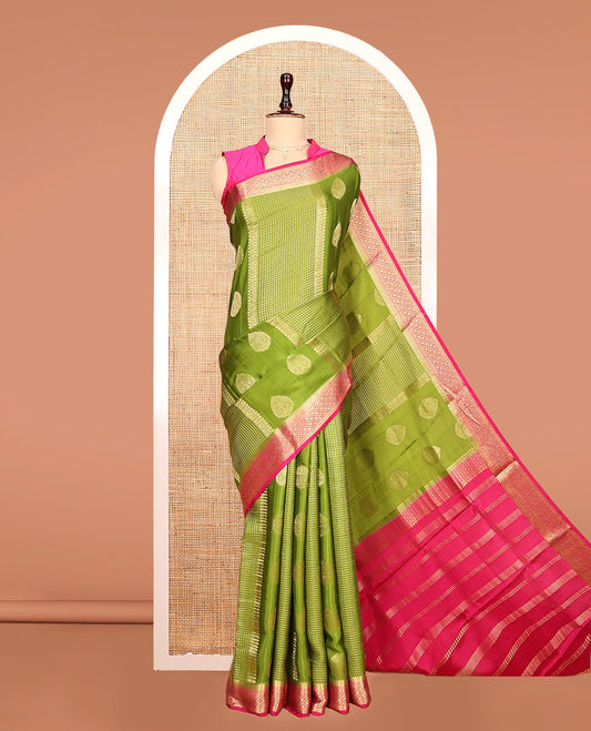 Green Mysore Silk Saree, Richly Detailed with Zari Buttas All Over Its Body, Complemented by a Contrast Traditional Zari Design Border, Pallu Steeped with Zari Stripes, and Paired with a Contrast Blouse