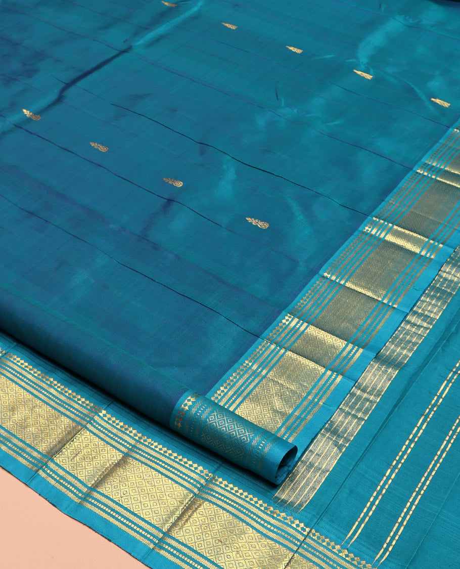 Blue Kanchipuram Silk Saree, Adorned with Zari Buttas, Complemented by a Contrast One-Sided Border of Panner Sombu, Banaras, Muthu, and Mayil Kann Designs, Grand Pallu, and No Blouse