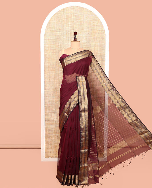 Maroon Plain Maheshwari Cotton Saree, Showcasing Traditional Zari Designs Woven Border, Pallu Steeped with Zari Stripes, and Paired with a Matching Blouse