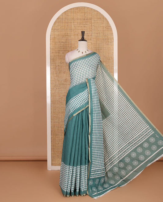 Green plain and polka dots printed linen cotton saree with piping zari border, floral-geometric print pallu, and contrast flower buttas printed  blouse