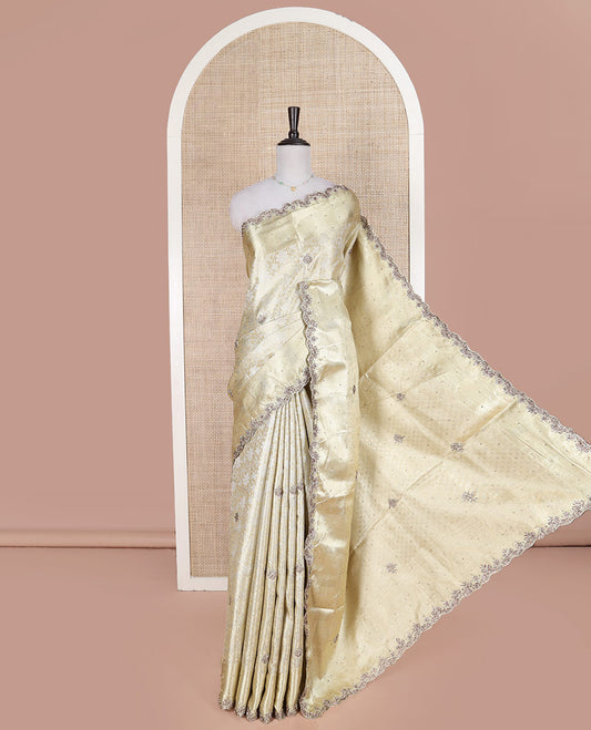Cream Vastrakala Silk Saree, Enlivened with Floral Jacquard and Patch Stone Work, Highlighted by Traditional Zari and Intricate Stone Embroidered Scallop Border, Grand Jaal Design Stone Work Pallu, and Paired with Heavy Embroidered Blouse