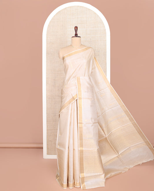 Sandal Tussar Silk Saree, Subtly Sparkled with Jhumka Buttas All Over Its Body, Subtle Piping Border, Pallu Features Chevron Stripes, and Paired with a Matching Blouse