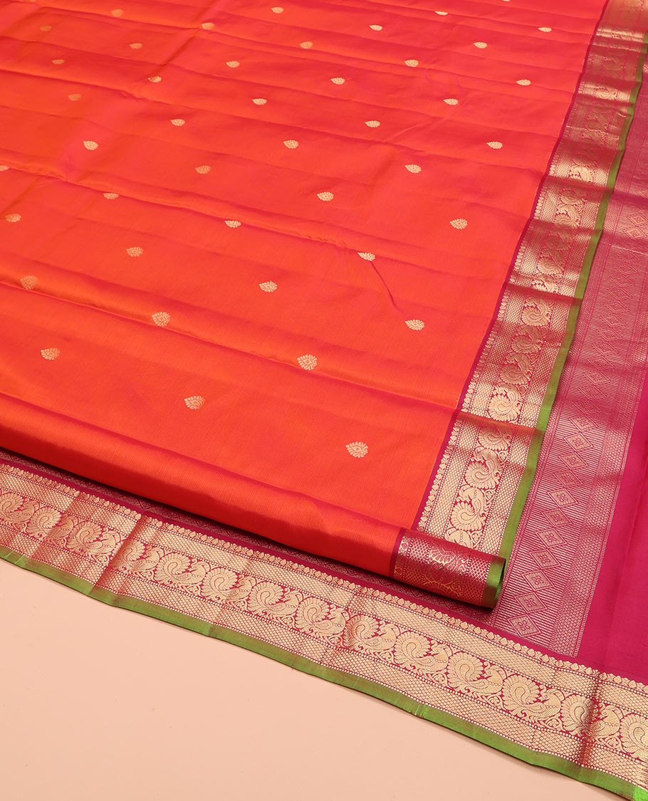 Orange Kanchipuram Silk Saree, Enthralled with Zari Buttas on Its Body, Complemented by a Contrast Border of Thilakam Mokku, Muthu, Mayil Kann, and Mayil Designs, Opulently Embellished Jaal Pallu, and Paired with a Contrast Blouse