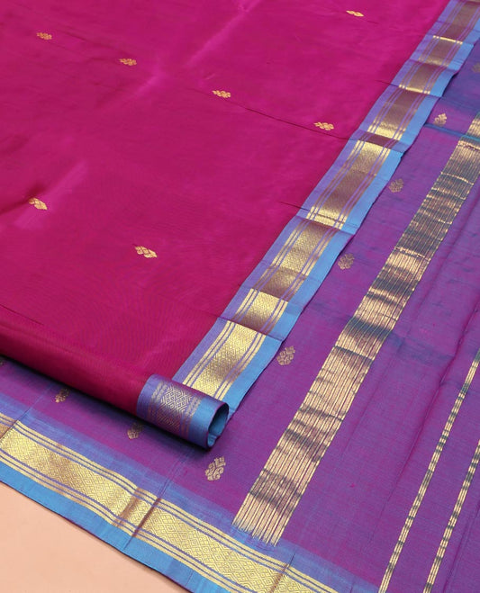 Magenta Kanchipuram Silk Saree, Adorned with Zari Buttas on Its Body, Complemented by a Contrast One-Sided Border of Banaras and Jaal Designs, Pallu Features Zari Designs, and Comes Without a Blouse