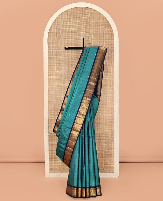 Blue Kanchipuram Silk Saree, Beautified with Zari Buttas All Over Its Body, Complemented by a Contrast Border of Thilakam, Muthu, Poun, and Vanki Designs, Grand Jaal Pallu, and Paired with a Contrast Blouse