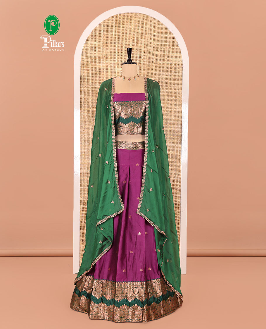 Purple and Green Semi-Banarasi Half-Saree Accentuated with Zari Buttas on Its Skirt, Complemented by Contrast Traditional Zari Border of Chakram Designs, Paired with a Matching Blouse, and a Satin Georgette Embroidered Scallop Dhavani