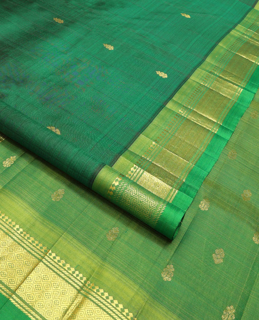 Dark green buttas kancheepuram silk saree with contrast border of thilakam mooku, banaras, muthu design & zari design pallu
