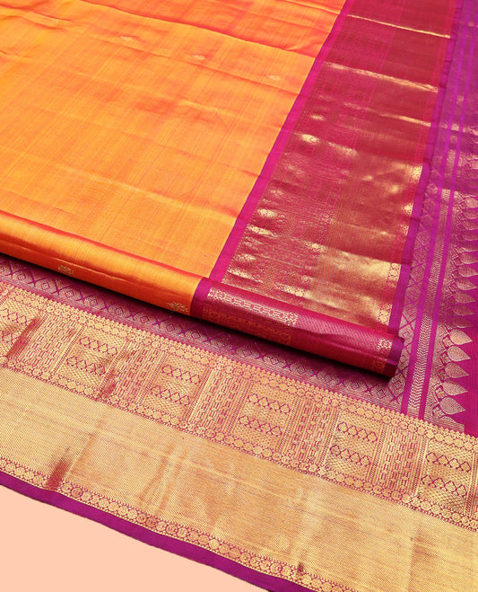 Orange Kanchipuram Silk Saree, Decked Up with Zari Buttas All Over Its Body, Complemented by Contrast  Border of Traditional Designs, Pallu of Jaal Designs, and Paired with a Contrast Blouse