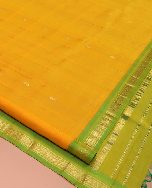 Yellow Kanchipuram Silk Saree, Subtly Sparkled with Zari Buttas, a Contrast One-Sided Border of Banaras, and Mayil Kann Design, Zari-Woven Pallu, and No Blouse