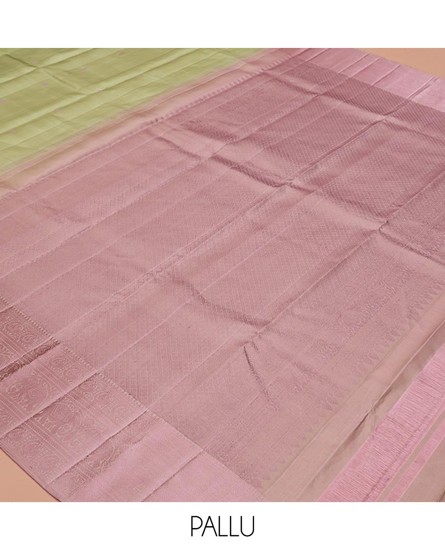 Pale Green Kanchipuram Designer Silk Saree, Subtly Sparkled With Buttas All Over Its Body Complemented by Contrast Traditional Designs Threaded Border, Subtly Woven Pallu, and Paired with a Contrast Blouse