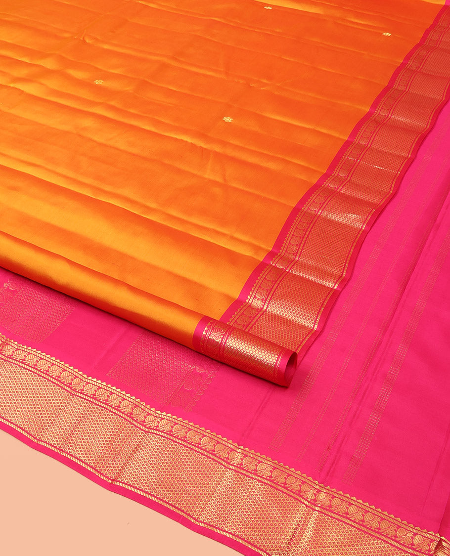 Orange Kanchipuram Silk Saree Decked Up with Zari Buttas, Complemented by Contrasting Border of Rekku, Banaras, Mayil, and Mayil Kann Designs, Pallu Mirroring the Same Border Design, and Paired with a Contrast Blouse