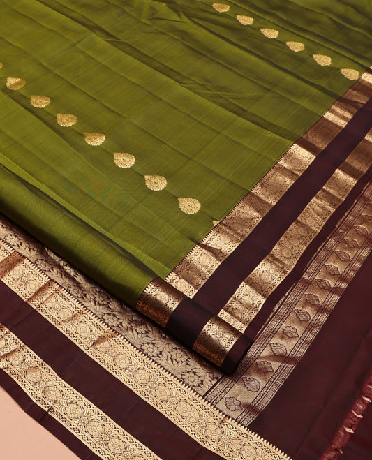 Green Mayuri Lite Silk Mix Saree, Ornamented with Zari Buttas All Over Its Body, Complemented by Contrast Zari Rettai Pettu Traditional Border, Floral Jaal Pallu, and Paired with a Contrast Blouse