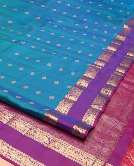 Blue Vasundhara Lite Silk Mix Saree, Majestically Detailed with Chakram Buttas on Its Body, Complemented by a Contrast Rettai Pettu Border of Salngai, Muthu, Mayil, and Yaali Designs, Intricately Designed Pallu, and Paired with a Contrast Blouse