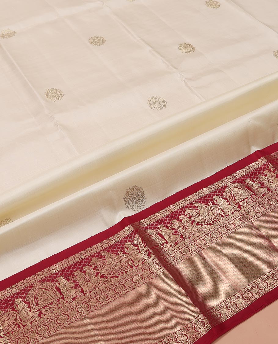 Cream Pure Silk Half-Saree, Enthralled with Zari Buttas All Over Its Skirt, Complemented by Contrast Wedding-Theme Border of Poo Chakram and Rudraksham Designs, Paired with a Contrast Blouse, and Comes with a Dhavani of Ogee Patterns