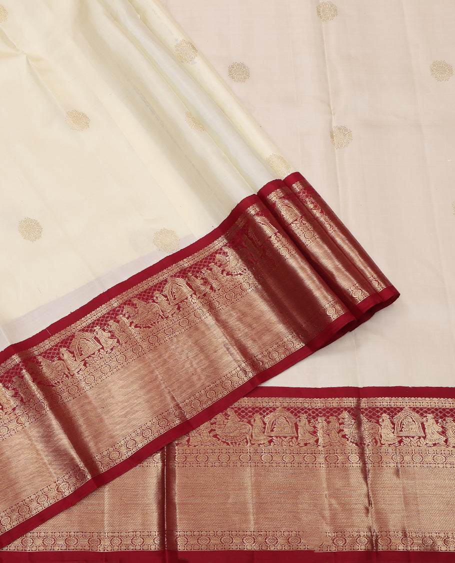 Cream Pure Silk Half-Saree, Enthralled with Zari Buttas All Over Its Skirt, Complemented by Contrast Wedding-Theme Border of Poo Chakram and Rudraksham Designs, Paired with a Contrast Blouse, and Comes with a Dhavani of Ogee Patterns