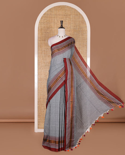 Grey-red plain design mul mul cotton saree, contrast copper zari horizontally striped border, plain pallu, and plain blouse