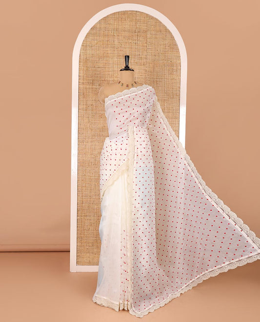 Half-white polka dots embroidered organza silk saree, scallop lace work border, and a matching lace bordered blouse