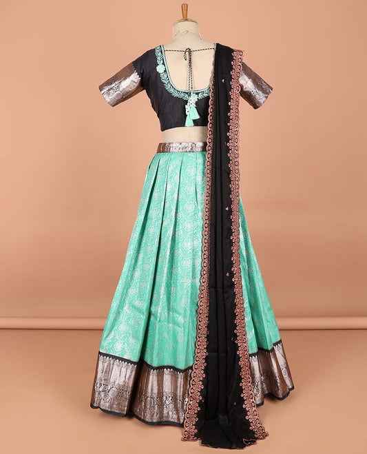 Green floral jacquard semi-stitched half saree with contrast zari border,  embroidered blouse & scallop border dhavani
