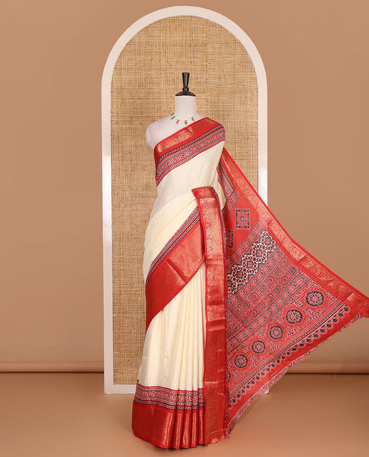 Cream-red zari striped dola silk saree, contrast traditional zari border of leaf creeper, Ajrakh printed pallu, and Ajrakh printed blouse