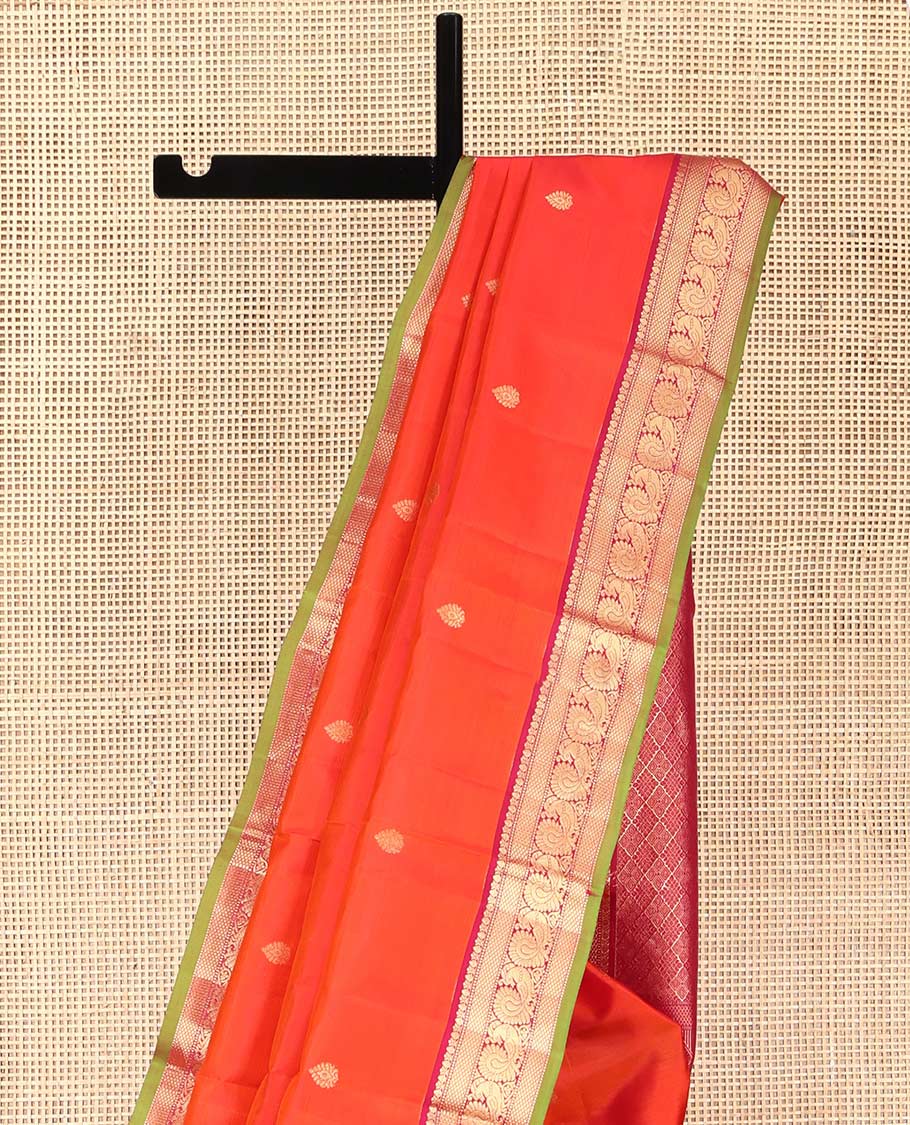 Orange Kanchipuram Silk Saree, Enthralled with Zari Buttas on Its Body, Complemented by a Contrast Border of Thilakam Mokku, Muthu, Mayil Kann, and Mayil Designs, Opulently Embellished Jaal Pallu, and Paired with a Contrast Blouse