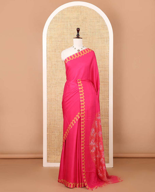 Rani pink plain gajji silk saree features a temple-printed border, a circular-shaped vine-patterned pallu, and a unique motif-printed blouse