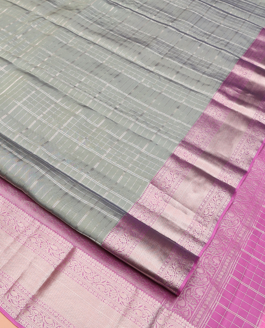Grey Vasundhara Lite Silk Mix Saree, Gracefully Embellished with Zari Checks On Its Body, Complemented by Contrast Border of Thilakam, Poun, Muthu, Kodi Visiry, and Mayil Kann Designs, Grand Pallu and Paired with a Contrast Blouse